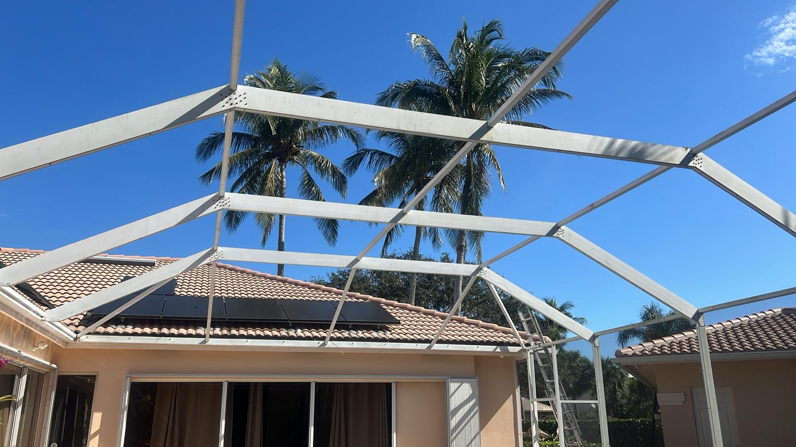 Pool enclosure interior before rescreening — bare aluminum frame, no screen panels, Boca Raton