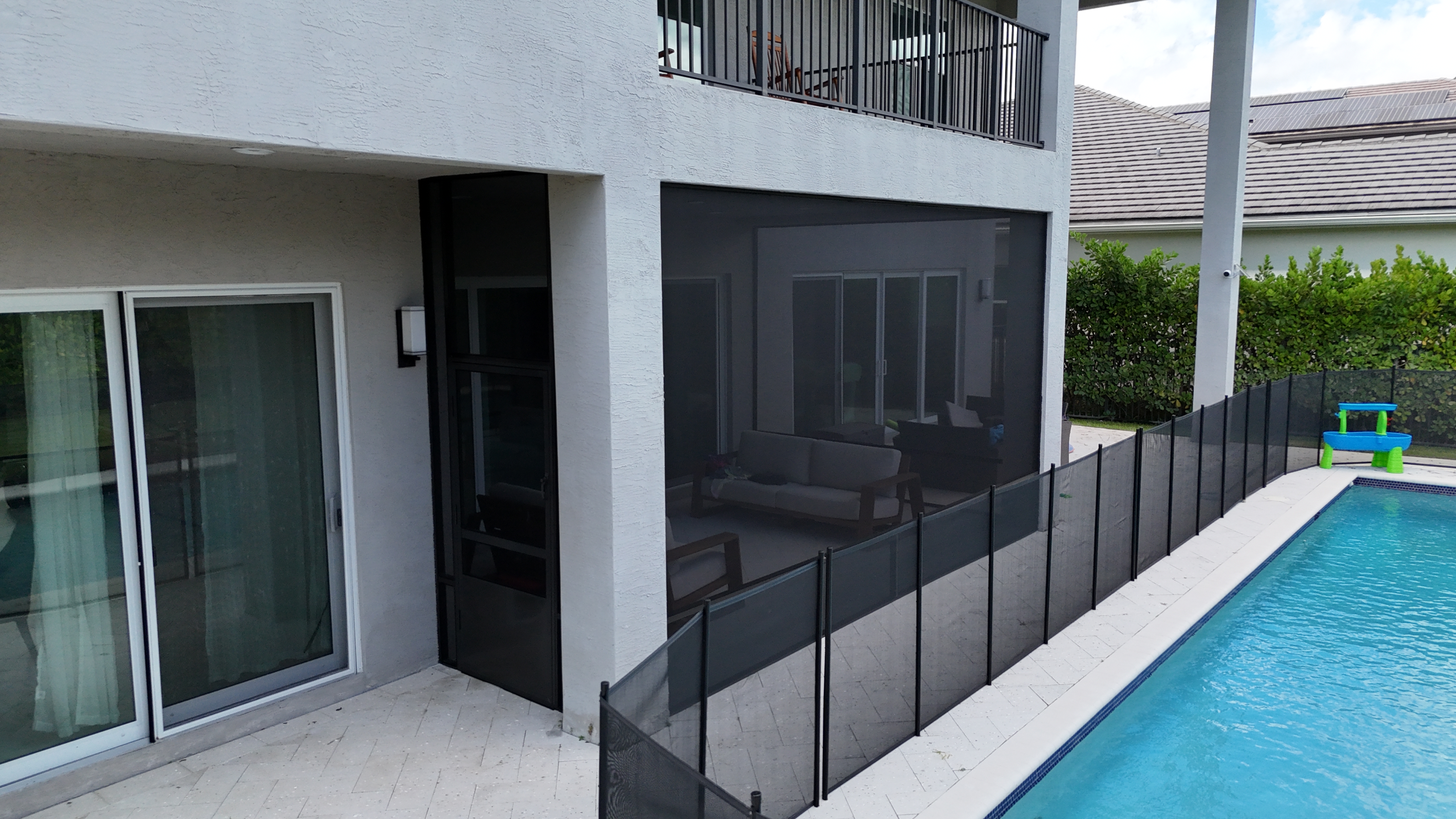 Completed pool screen enclosure at luxury two-story South Florida home