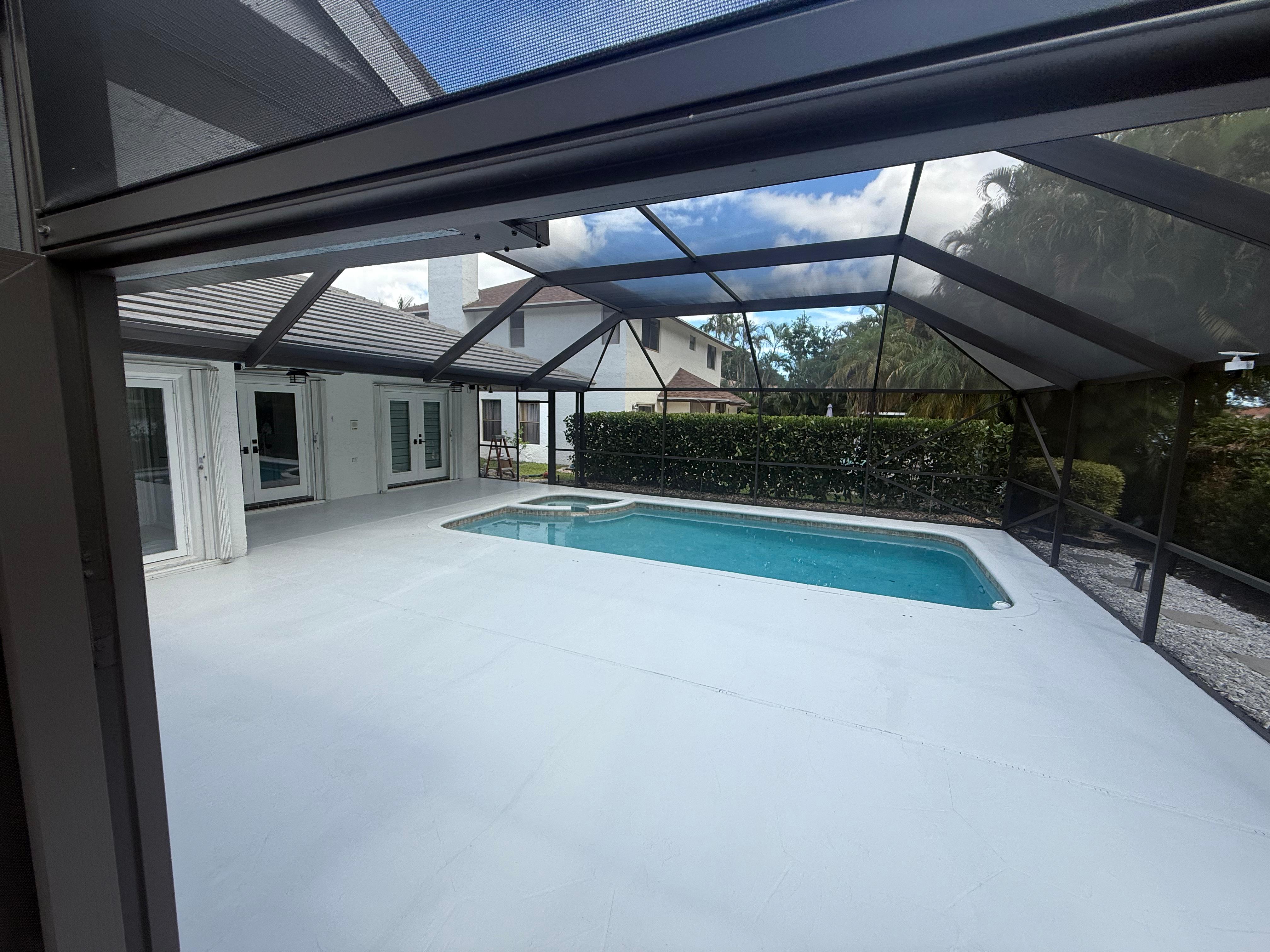 Interior view of pool and spa screen enclosure with glass panels