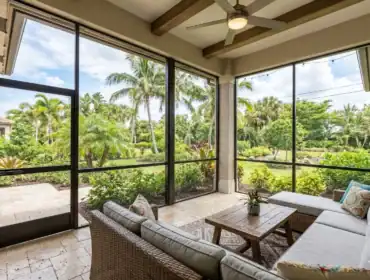 Luxury screened-in porch with high-quality aluminum framing and a view of tropical landscaping in West Palm Beach, FL.
